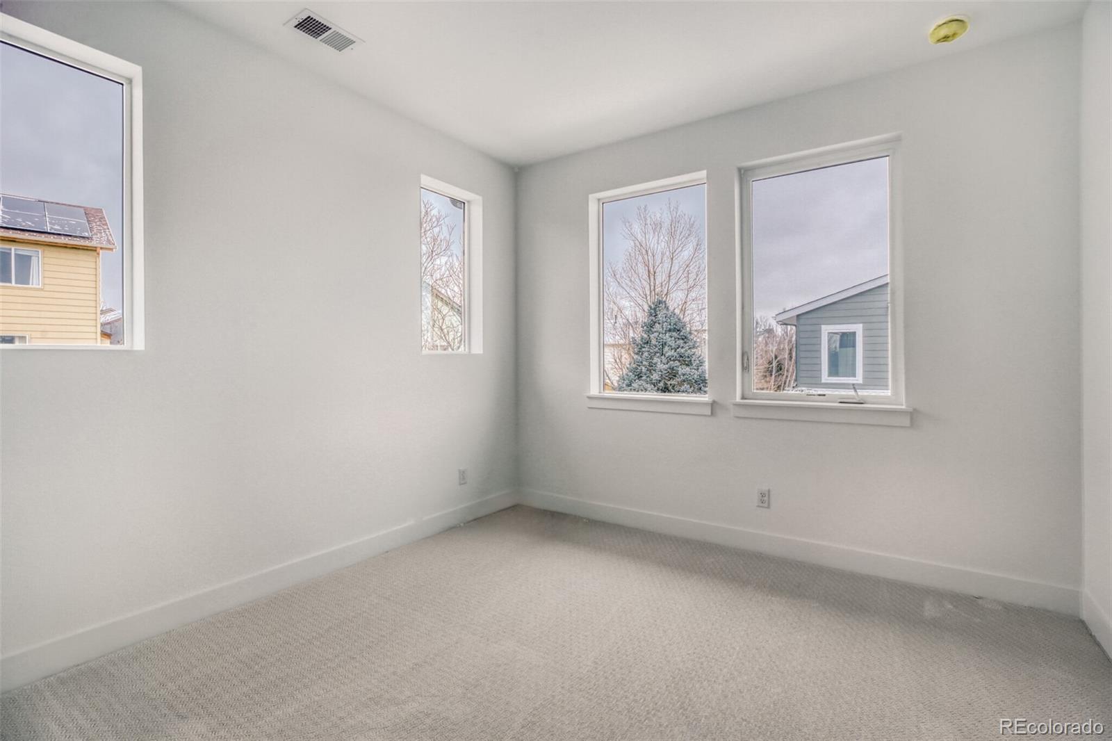 672 Apex Street Erie, CO 80516 - Photo 9 of 19 an empty room with windows