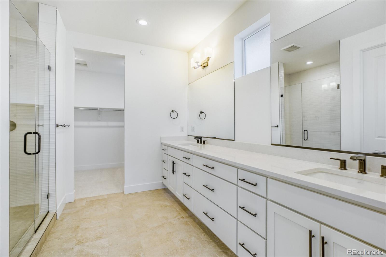 672 Apex Street Erie, CO 80516 - Photo 10 of 19 a bathroom with a granite countertop sink mirror and double