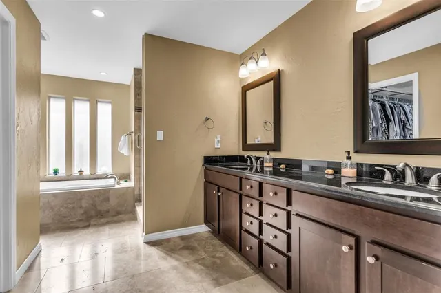 a bathroom with a double vanity sink and a mirror