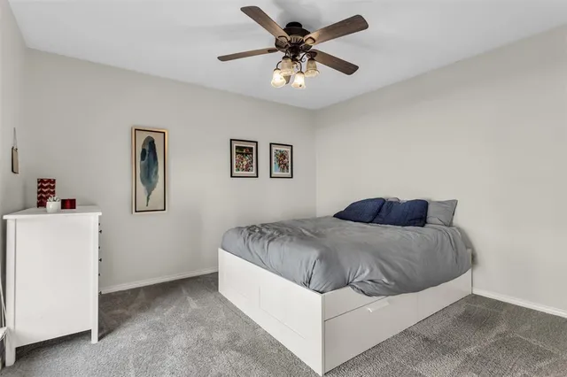a spacious bedroom with a bed and a chandelier