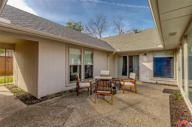 a view of a house with backyard and sitting area