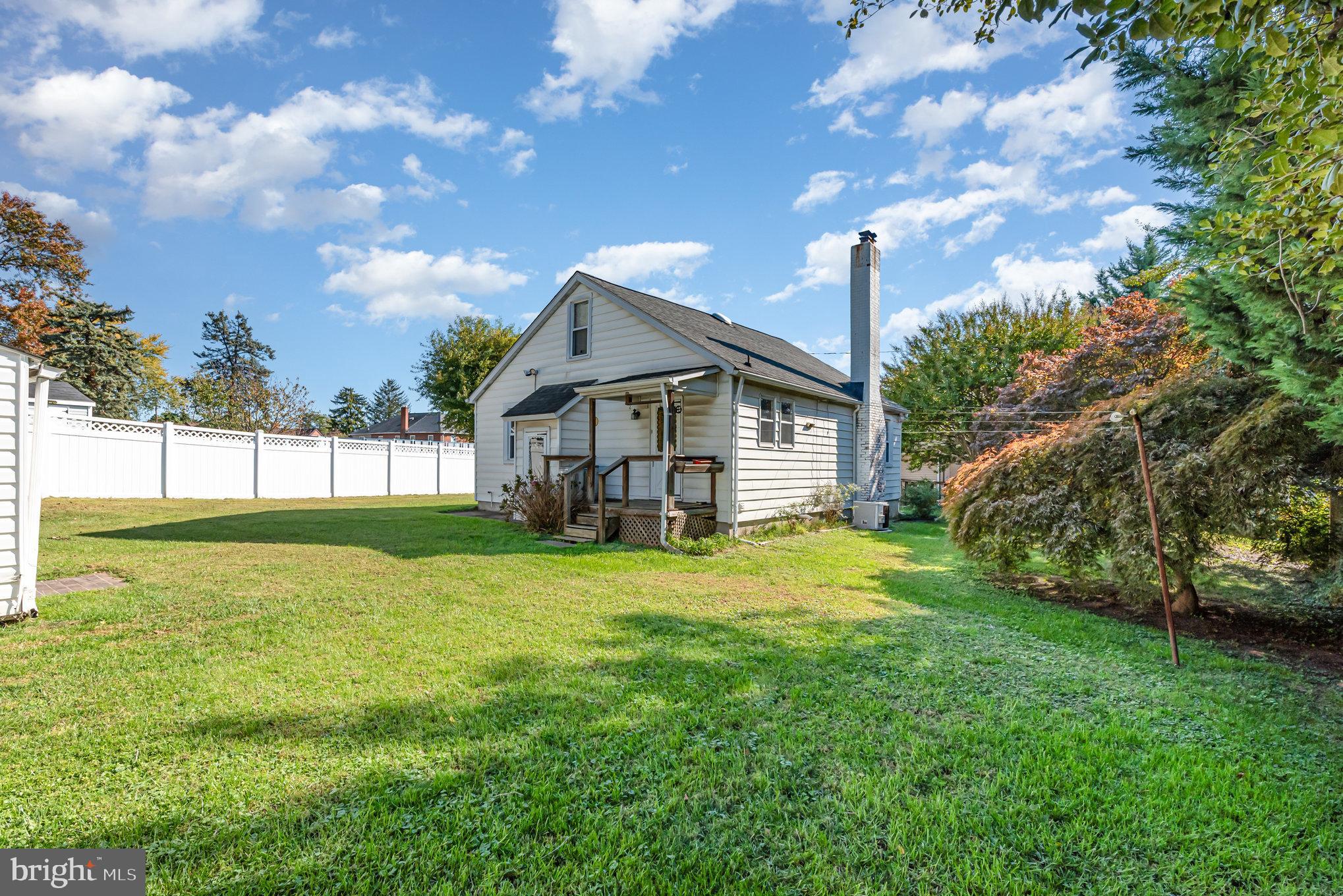1940 Robinwood Road Baltimore, MD 21222 - Photo 22 of 36 a front view of house with yard and trees in the background