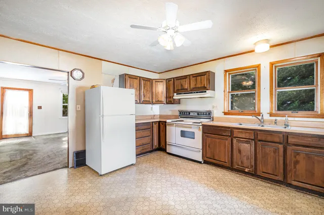 a kitchen with a refrigerator stove and sink