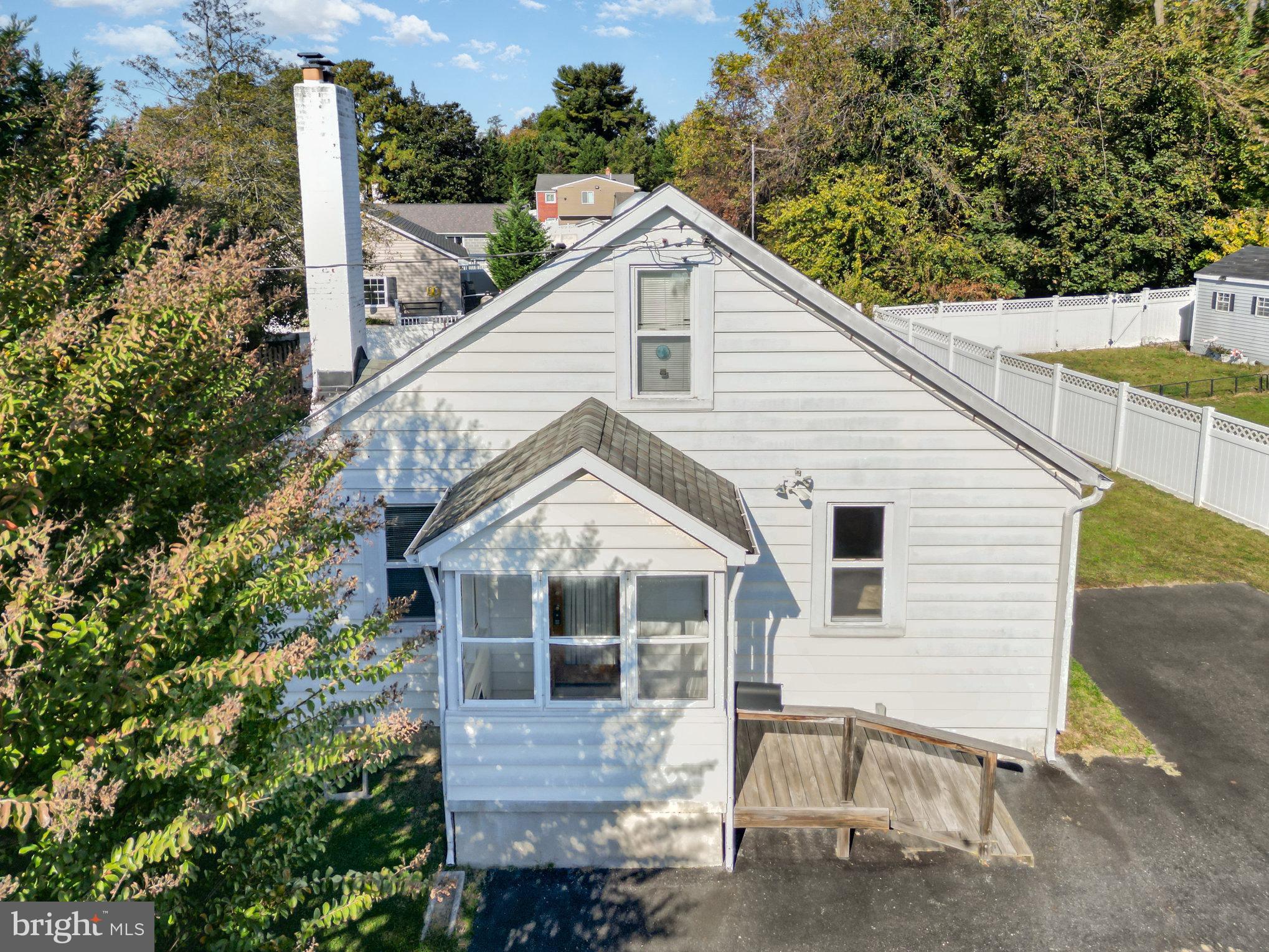 1940 Robinwood Road Baltimore, MD 21222 - Photo 31 of 36 a view of a white house next to a yard with wooden fence