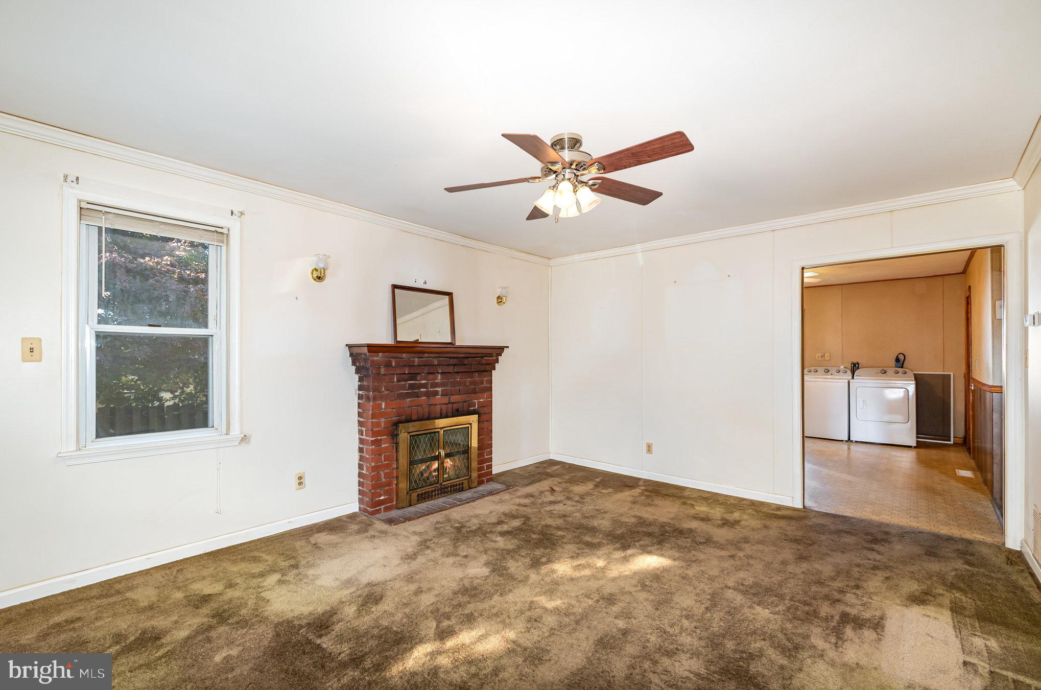 1940 Robinwood Road Baltimore, MD 21222 - Photo 5 of 36 a view of a livingroom with a ceiling fan and wooden floor
