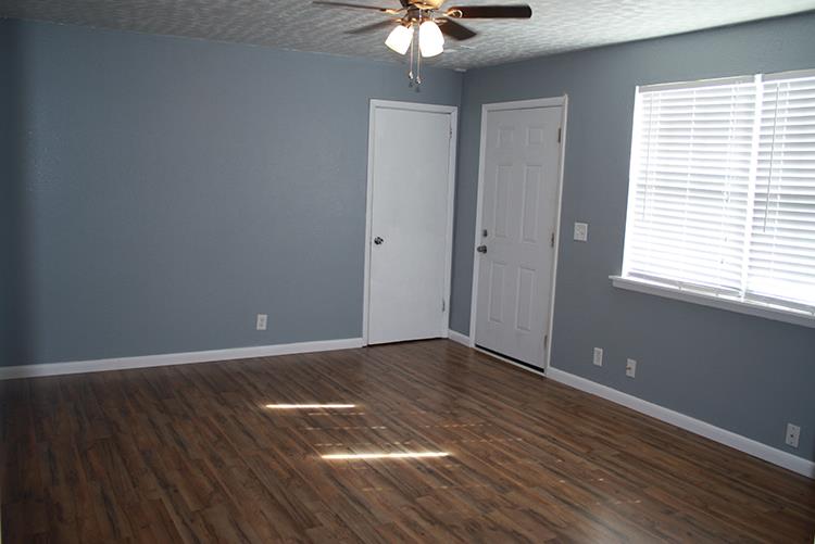 267 Raintree Drive Clarksville, TN 37042 - Photo 4 of 10 a view of an empty room with wooden floor and a window