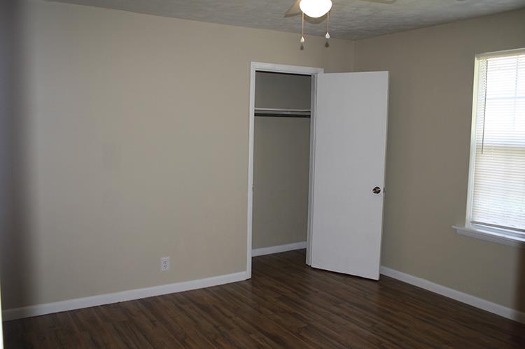 267 Raintree Drive Clarksville, TN 37042 - Photo 5 of 10 an empty room with wooden floor closet and windows