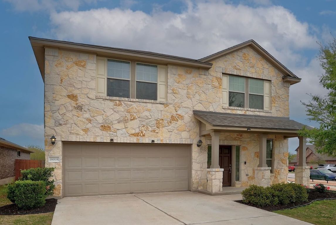 a front view of a house with garage