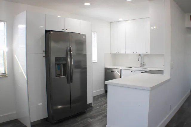 a kitchen with a sink cabinets and stainless steel appliances