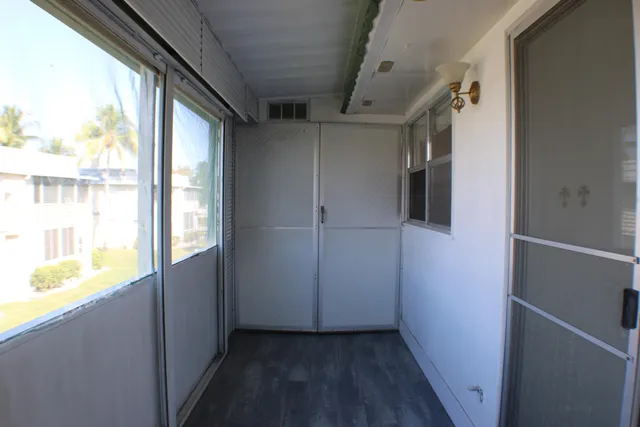 a view of walk in closet with wooden floor