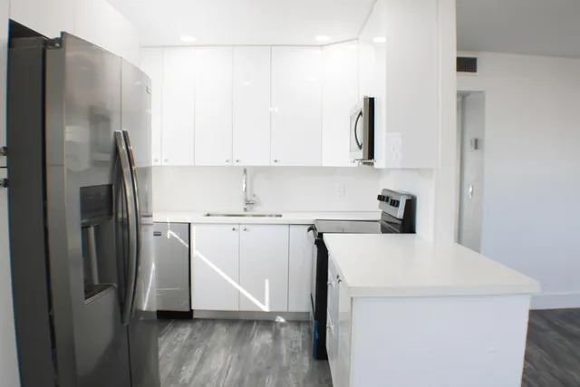 a kitchen with a refrigerator sink and stove