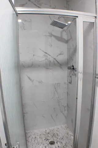 a bathroom with a glass shower door