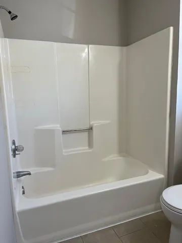 a bathroom with a bathtub and a toilet