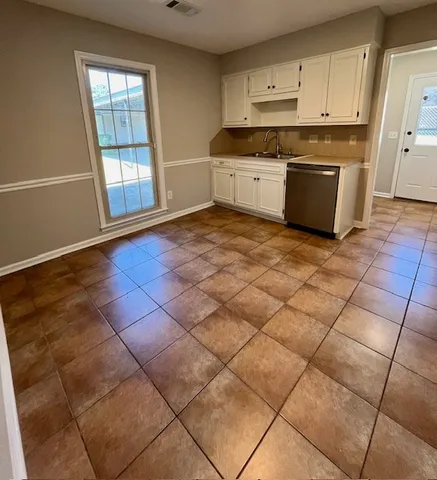 a kitchen with stainless steel appliances a sink and cabinets