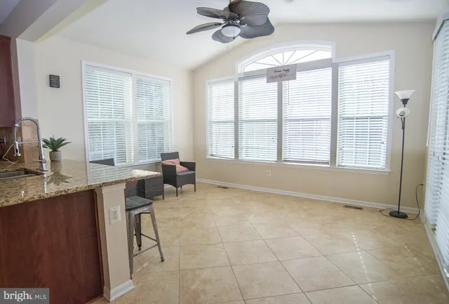 a kitchen with granite countertop wooden cabinets stainless steel appliances and a sink