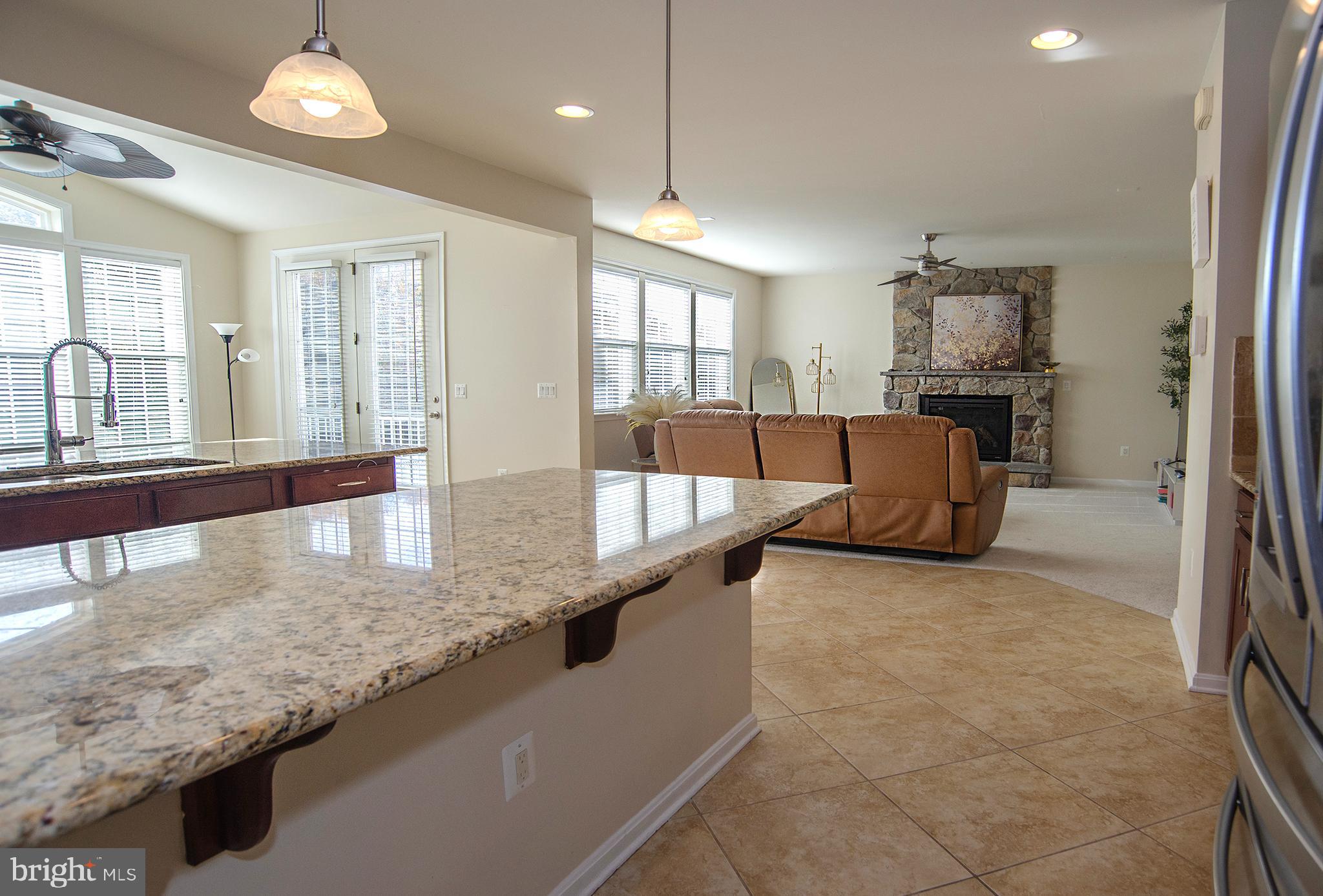 20 Aster Lane Stafford, VA 22554 - Photo 16 of 57 a large kitchen with kitchen island a large counter top stainless steel appliances and windows