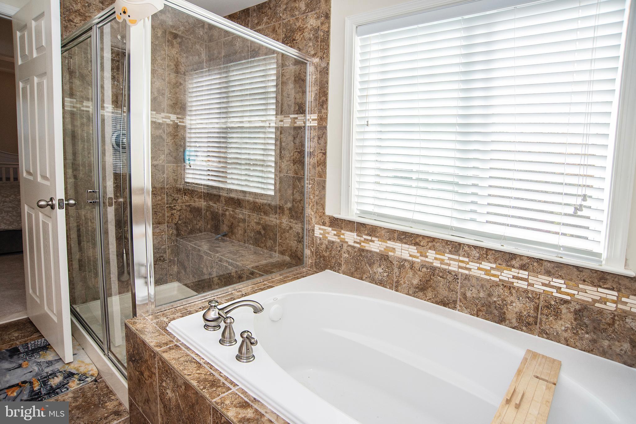 20 Aster Lane Stafford, VA 22554 - Photo 25 of 57 a bath tub sitting in a bathroom next to a window