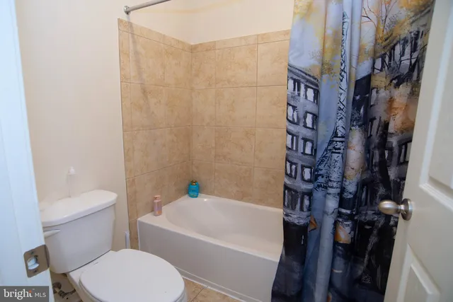 a bathroom with a sink mirror and toilet