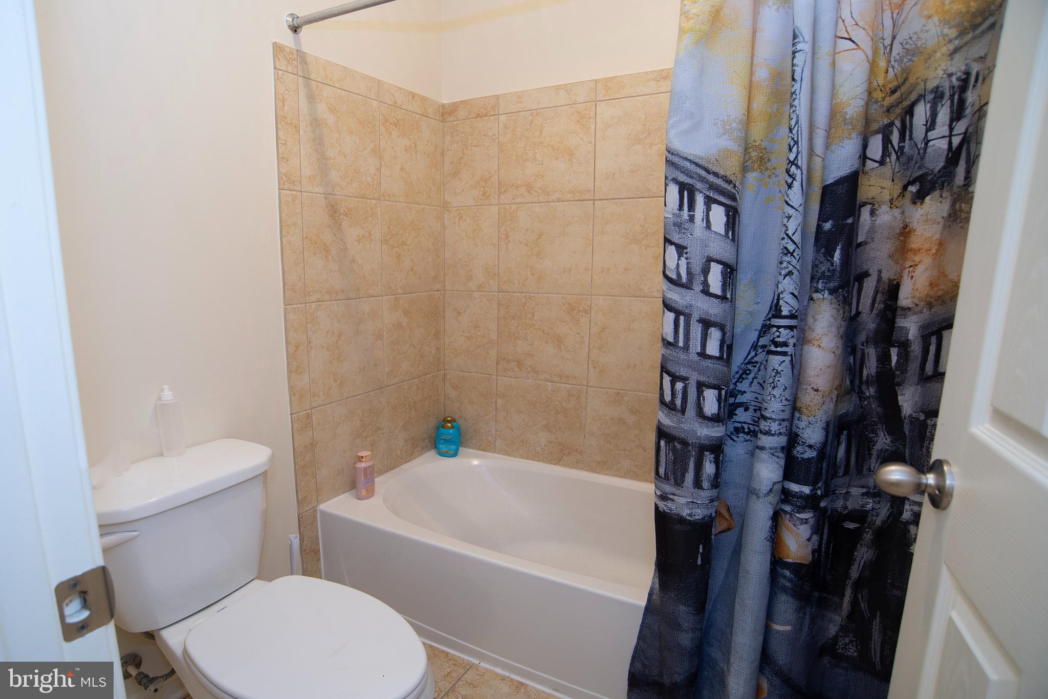 20 Aster Lane Stafford, VA 22554 - Photo 37 of 57 a white toilet sitting next to a bath tub