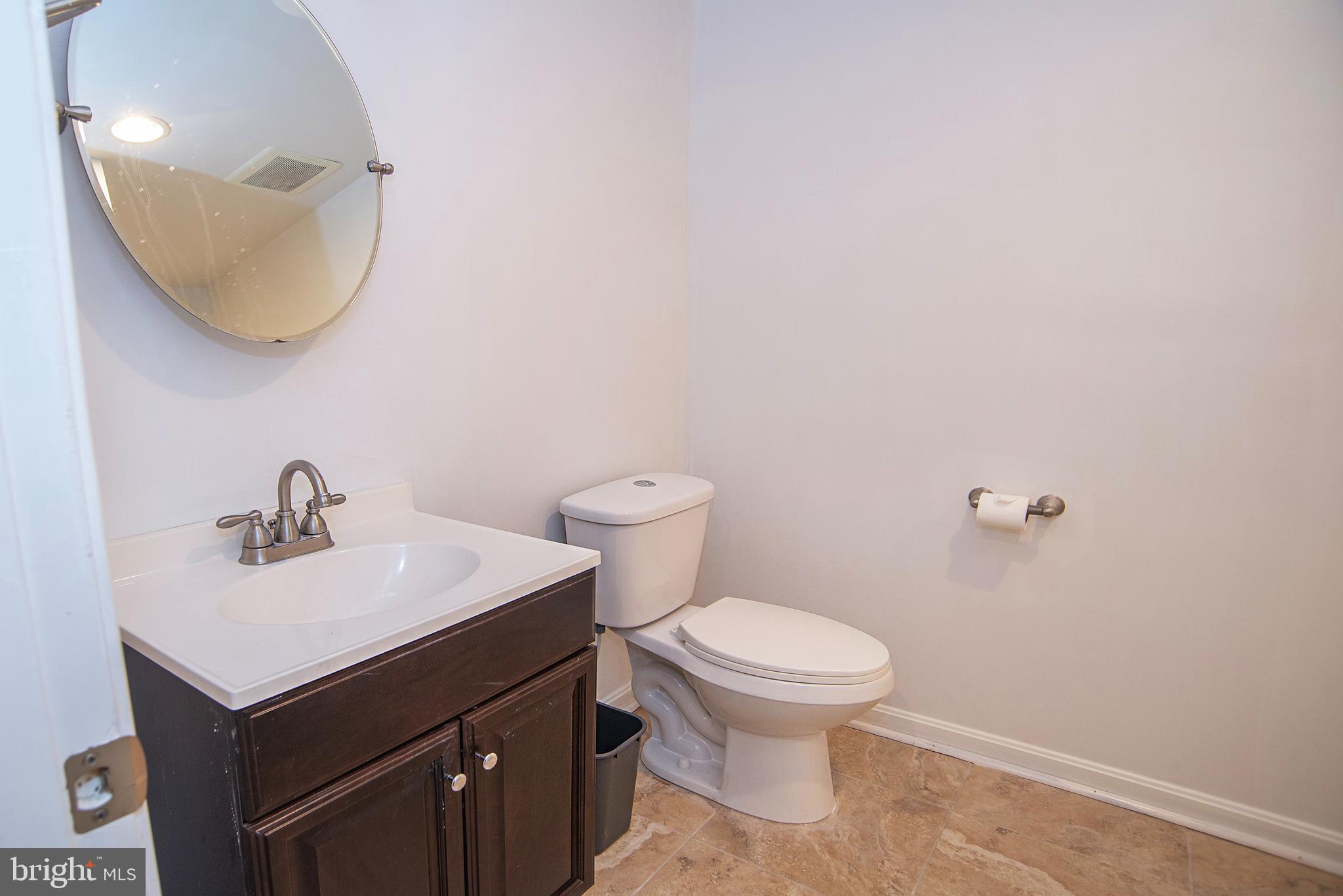 20 Aster Lane Stafford, VA 22554 - Photo 41 of 57 a bathroom with a sink mirror and toilet