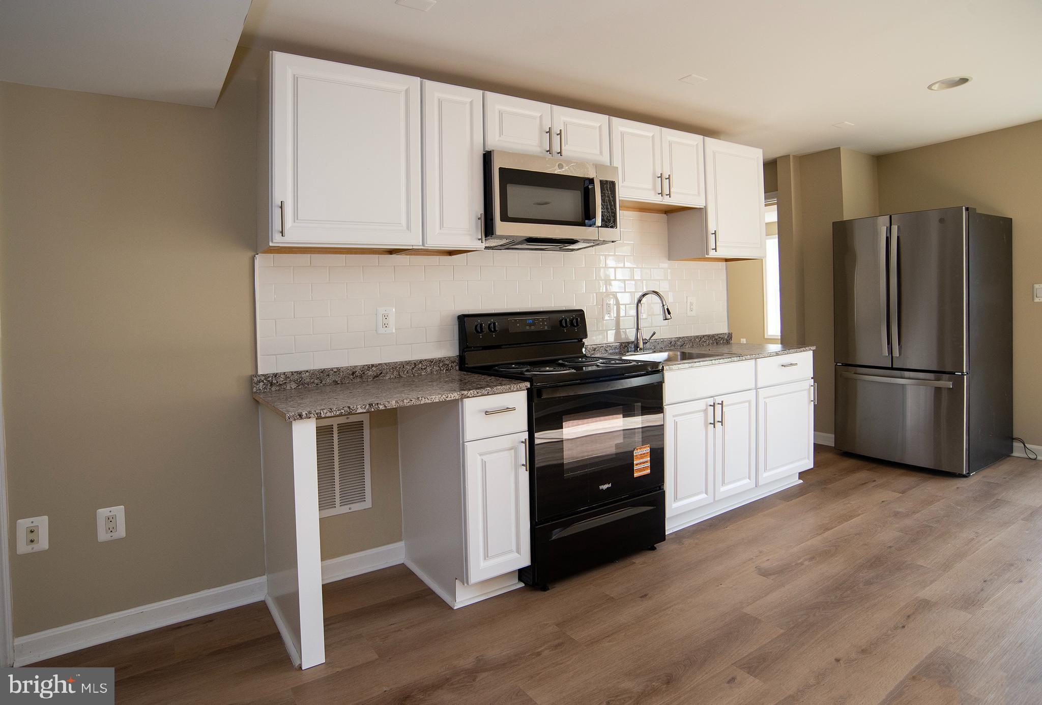 20 Aster Lane Stafford, VA 22554 - Photo 48 of 57 a kitchen with a refrigerator stove and microwave