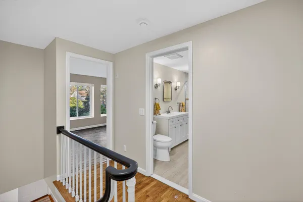 a view of a hallway with a livingroom and bathroom