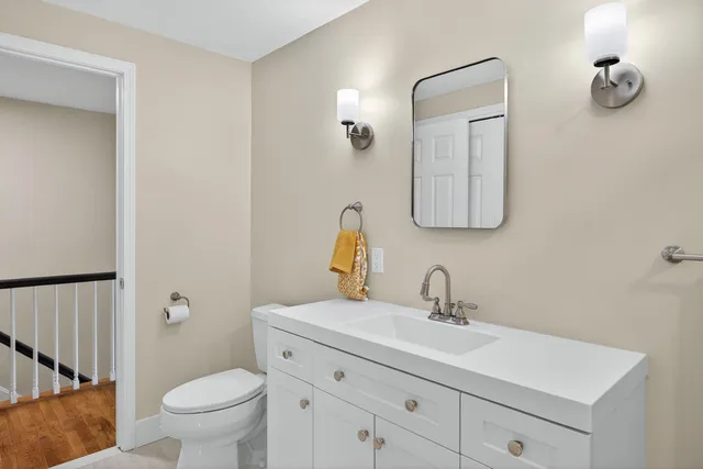 a bathroom with a sink mirror and shower