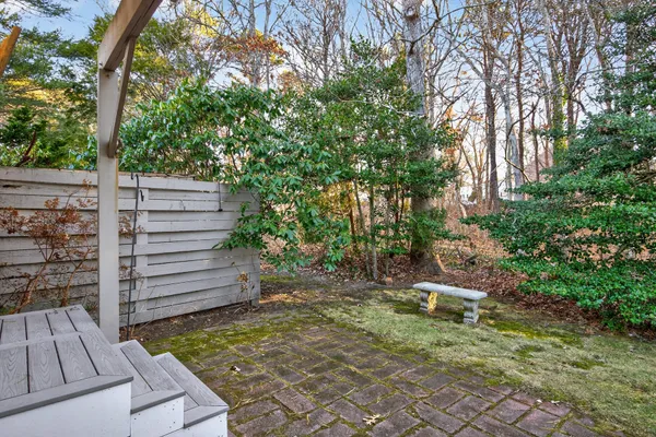 a front view of a house with plants and entryway