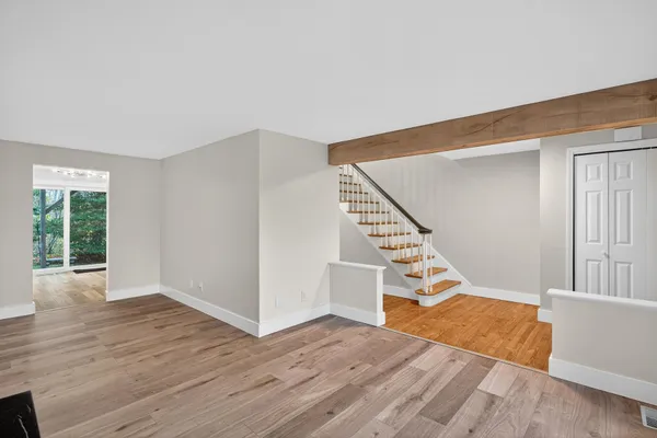 a view of entryway and hall with wooden floor