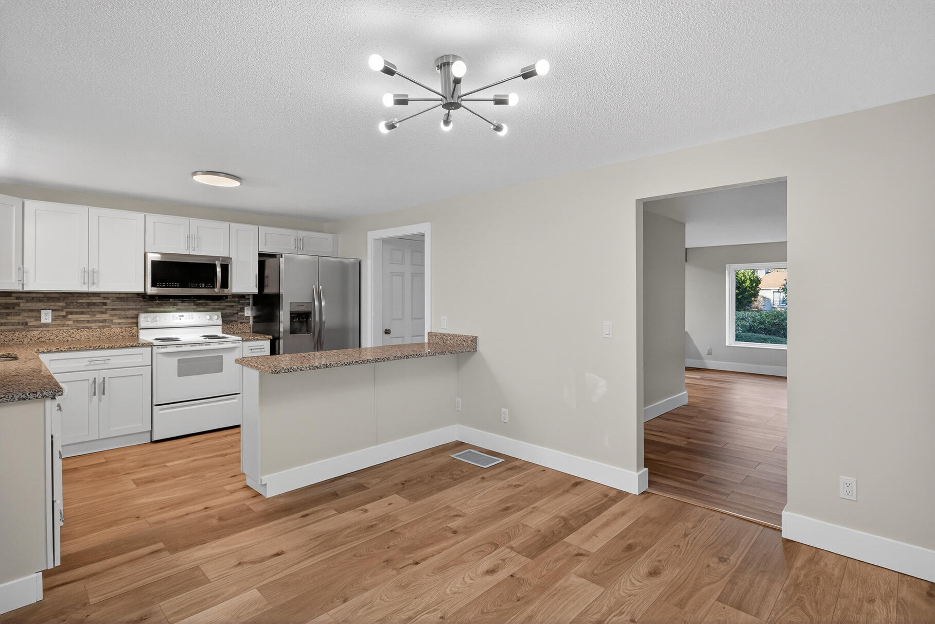 481 Buck Island Road, Unit 11BB West Yarmouth, MA 02673 - Photo 6 of 34 a kitchen with wooden floors and white appliances