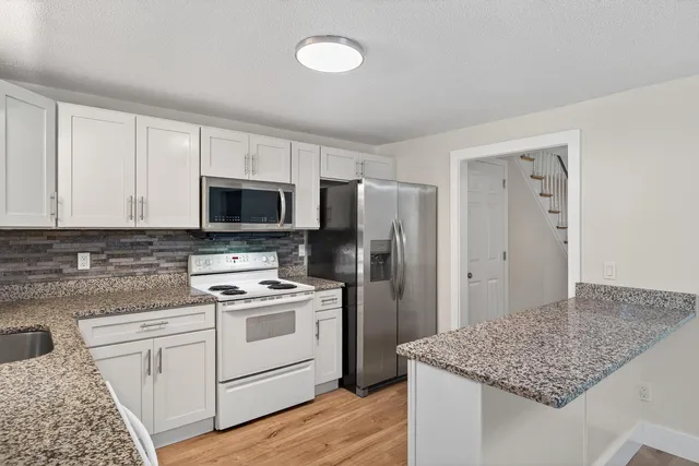 a kitchen with a stove microwave and refrigerator