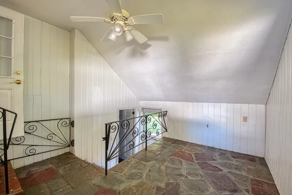 an entryway with hardwood and ceiling fan