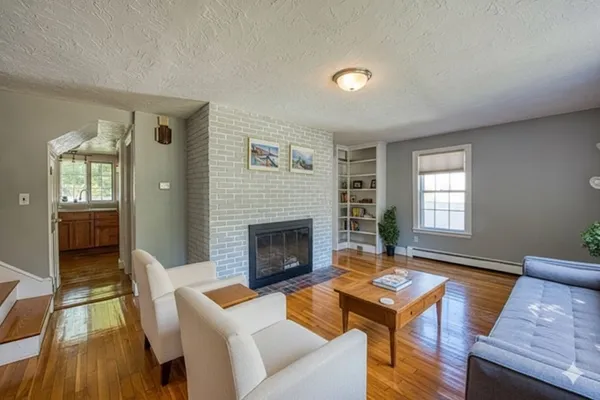 a living room with furniture and a fireplace