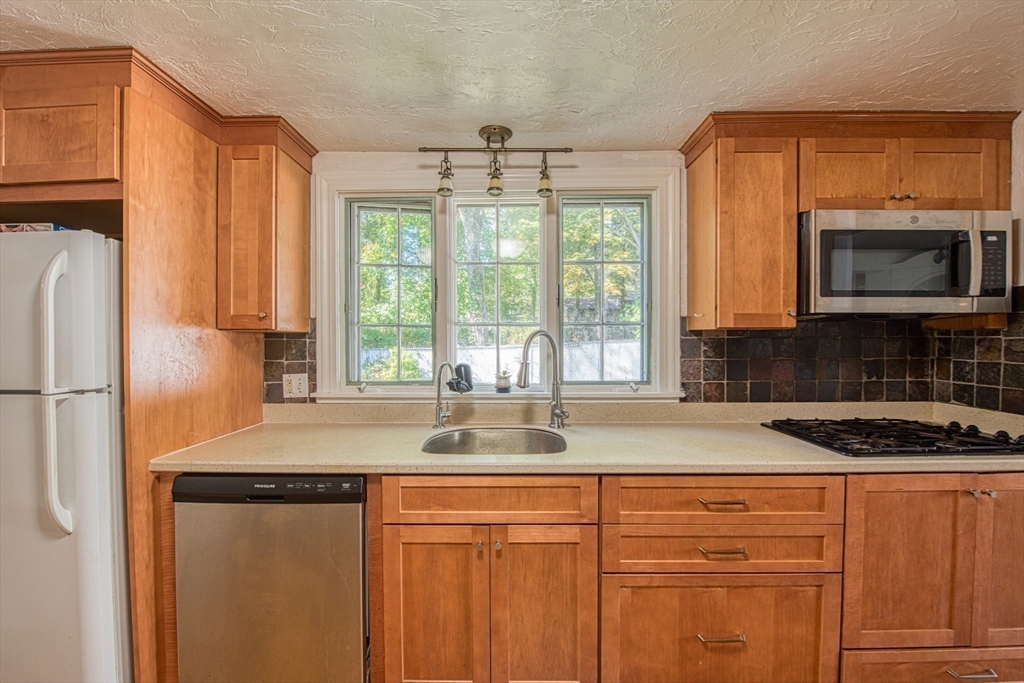 137 Pond Street Sharon, MA 02067 - Photo 8 of 23 a kitchen with granite countertop a sink stove and refrigerator