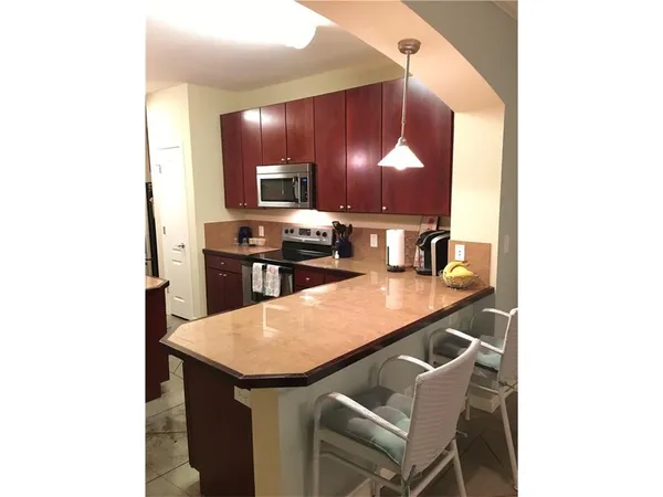 a kitchen with a sink cabinets and stainless steel appliances