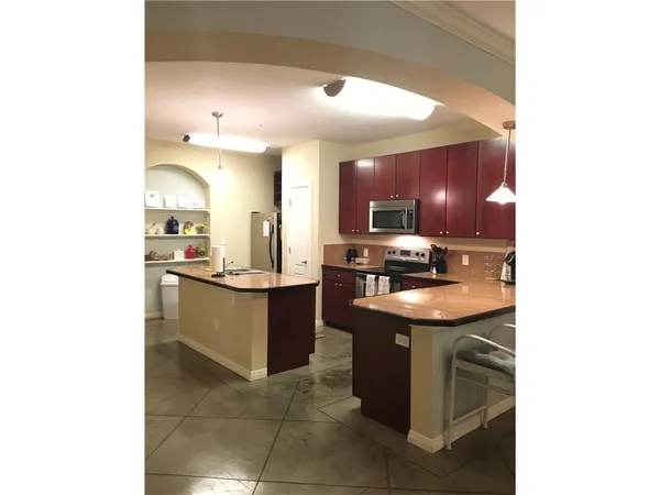 a kitchen with stainless steel appliances granite countertop a sink counter top space and cabinets