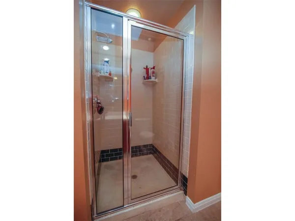a bathroom with a glass shower door