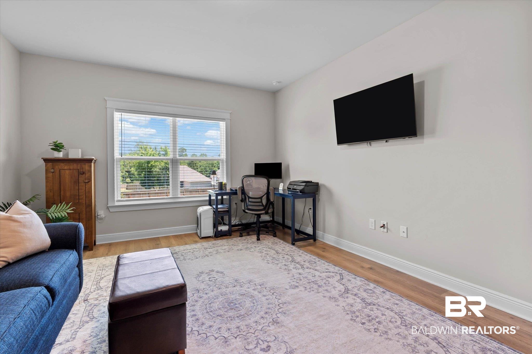 23523 Travis Stock Street Foley, AL 36535 - Photo 25 of 45 Room featuring wood-finish flooring, light-toned walls, and white baseboards