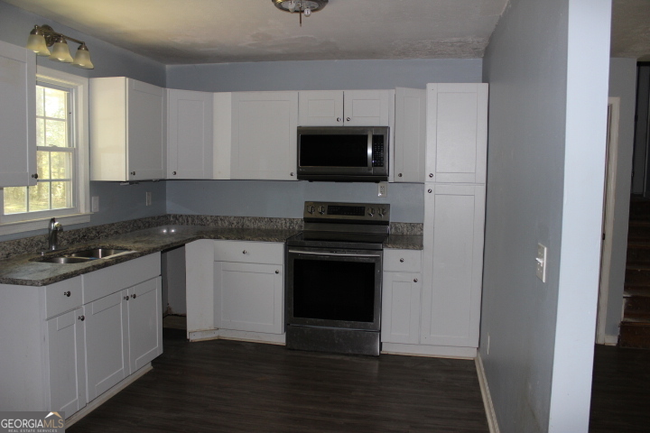 163 Terri Road LaGrange, GA 30240 - Photo 3 of 13 a kitchen with granite countertop a sink and a stove top oven