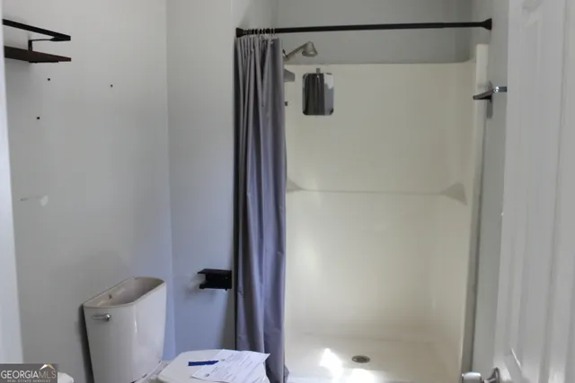 a bathroom with a shower and a toilet