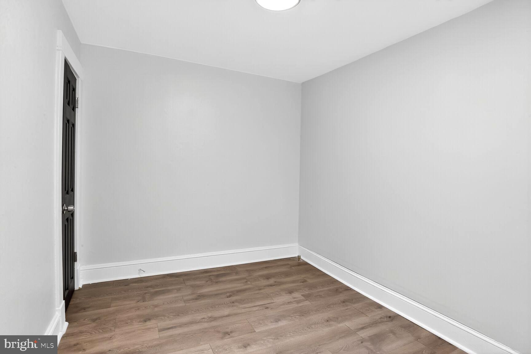 3808 6th Street Baltimore, MD 21225 - Photo 10 of 21 a view of an empty room with wooden floor