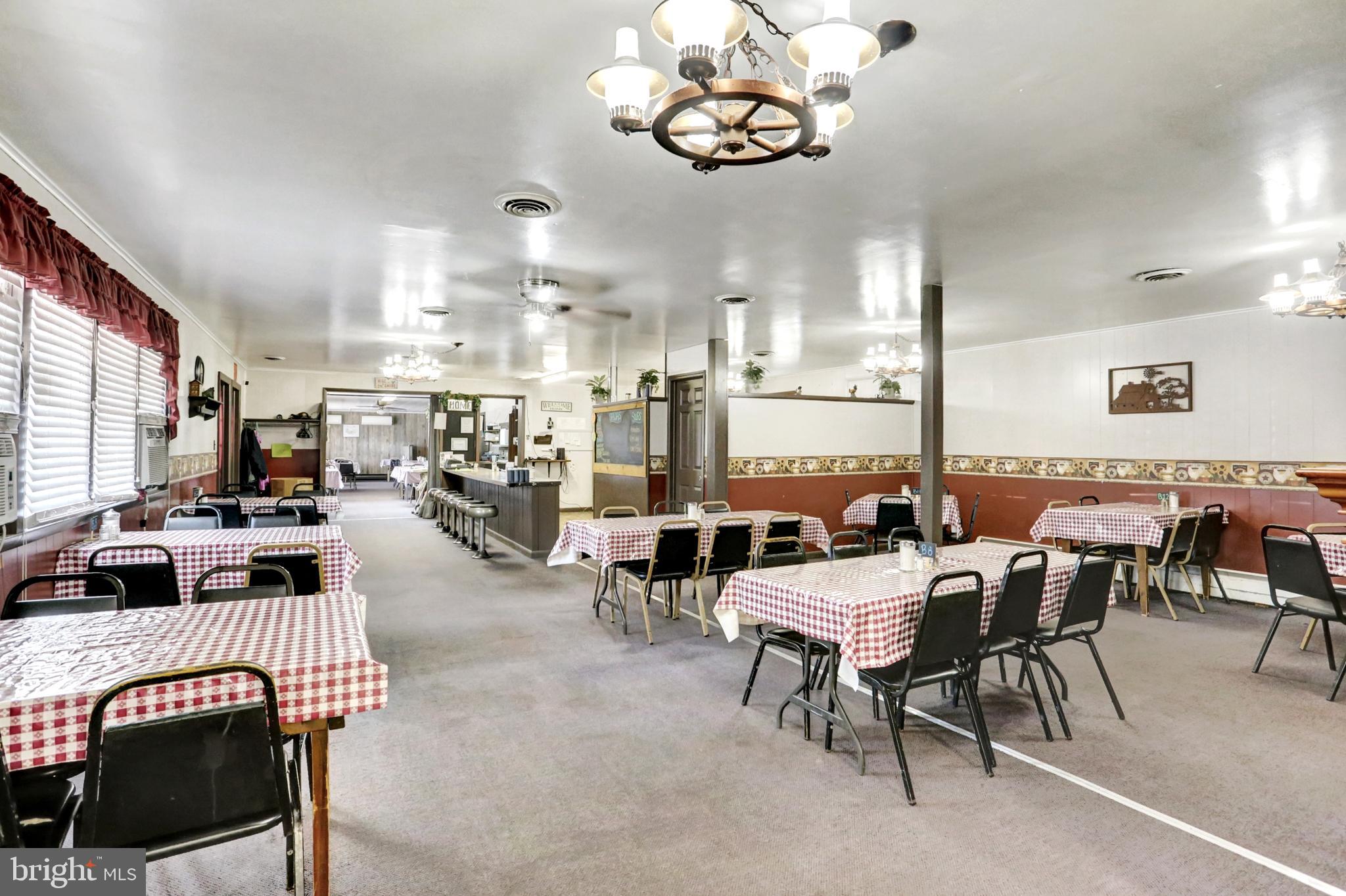 8370 Rte 104 Mount Pleasant Mills, PA 17853 - Photo 18 of 71 a living room with lots of furniture and a chandelier