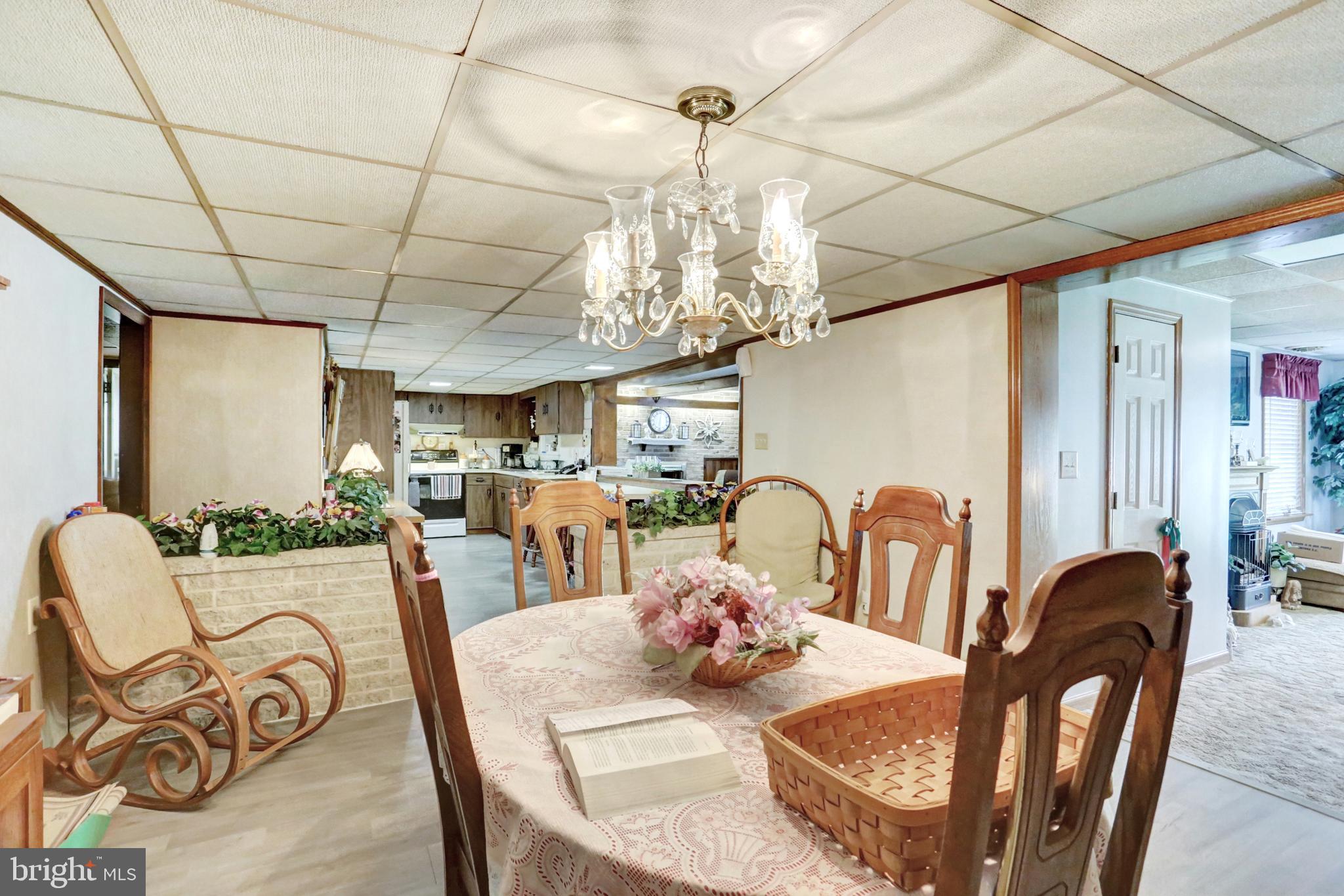 8370 Rte 104 Mount Pleasant Mills, PA 17853 - Photo 40 of 71 a view of a dining room with furniture a chandelier and wooden floor