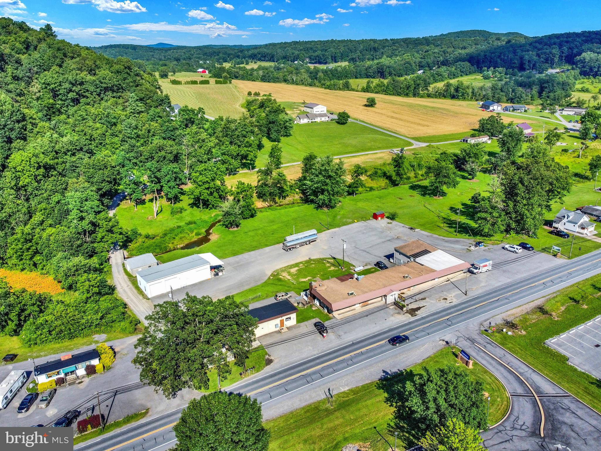 8370 Rte 104 Mount Pleasant Mills, PA 17853 - Photo 4 of 71 an aerial view of a house with a garden and lake view