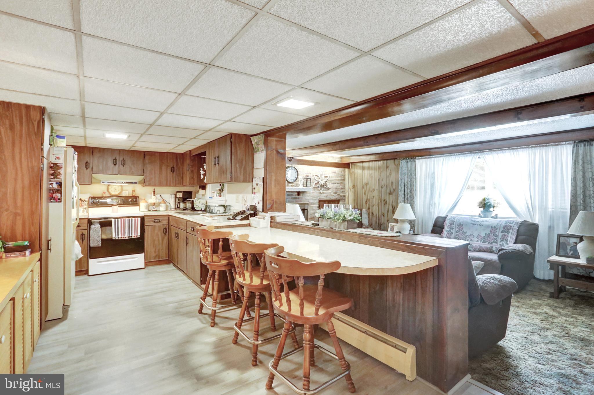 8370 Rte 104 Mount Pleasant Mills, PA 17853 - Photo 42 of 71 a open dining room with stainless steel appliances a table chairs refrigerator and kitchen view
