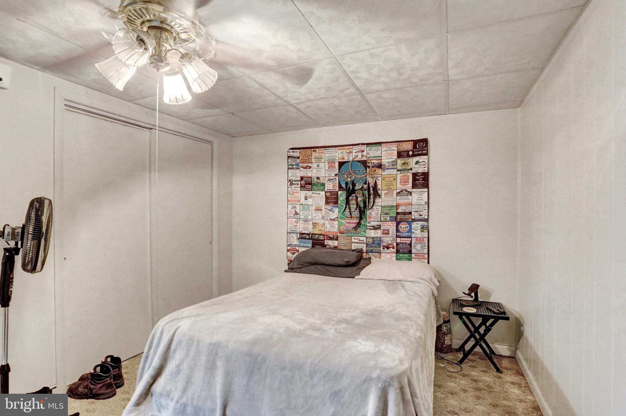 8370 Rte 104 Mount Pleasant Mills, PA 17853 - Photo 58 of 71 a bedroom with a bed and a chandelier