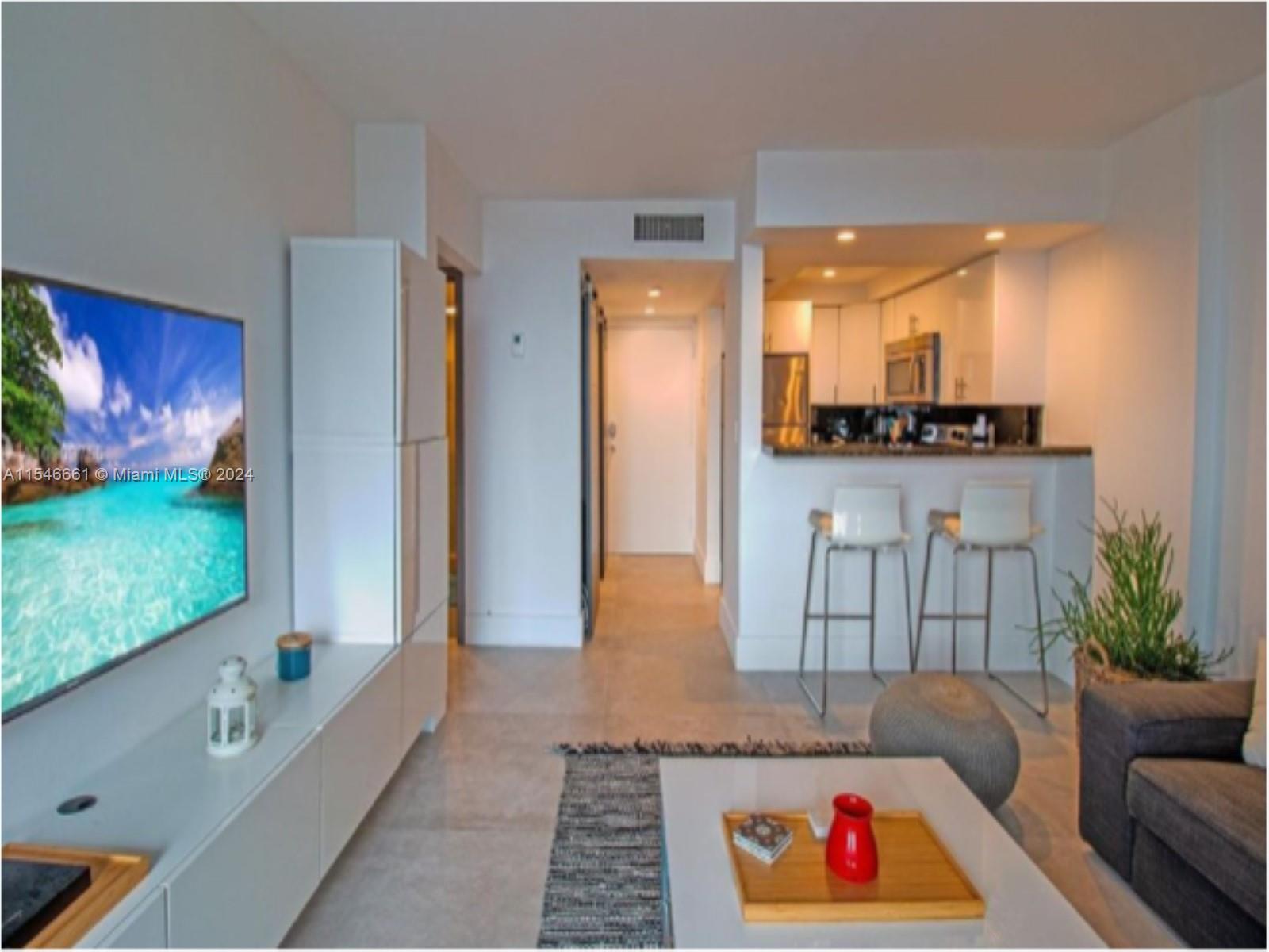 1035 West Avenue, Unit 802 Miami Beach, FL 33139 - Photo 2 of 14 a living room with furniture and a large window