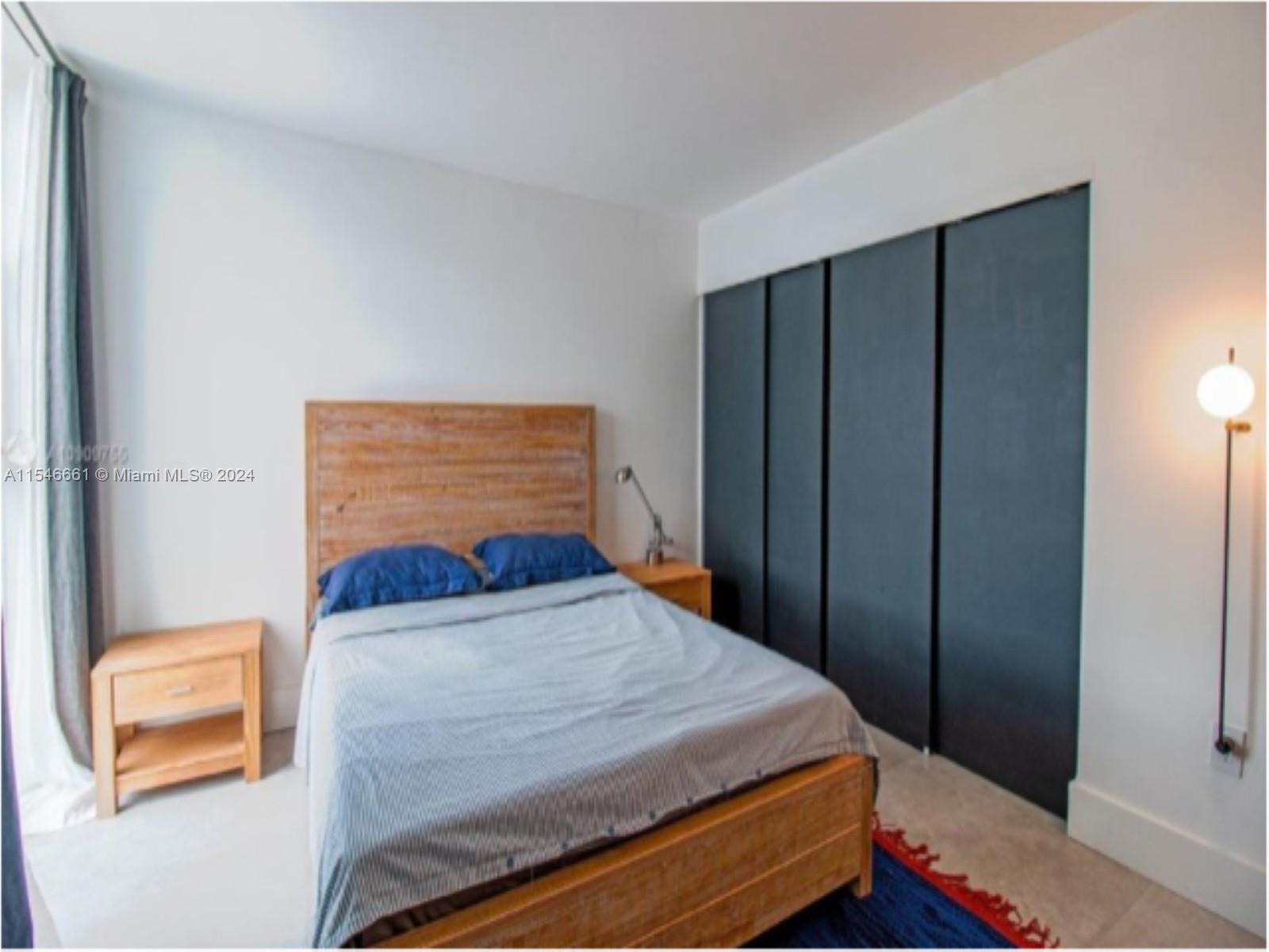 1035 West Avenue, Unit 802 Miami Beach, FL 33139 - Photo 7 of 14 a bedroom with a bed and a window