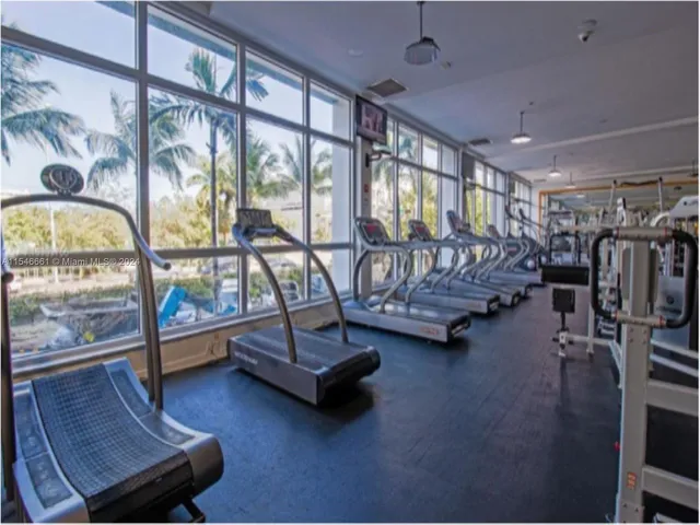 a living room with furniture a rug and a large window