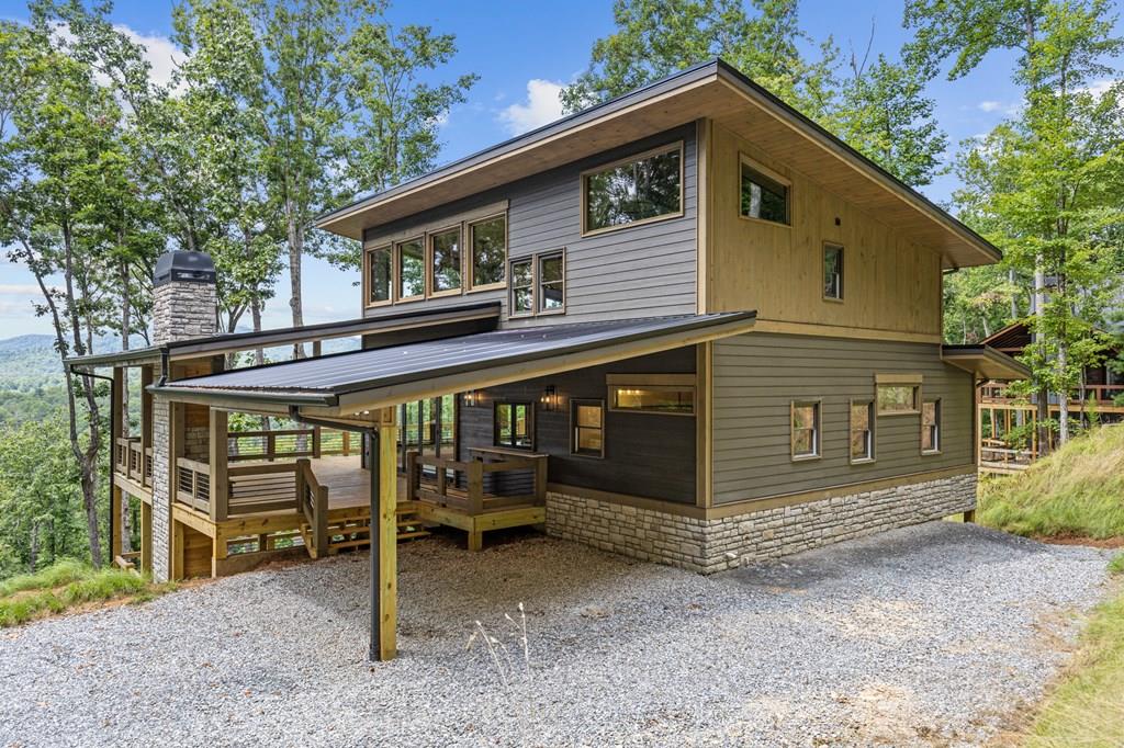 394 Mountain Trace Cherry Log, GA 30522 - Photo 1 of 70 a view of a house with a backyard space and balcony